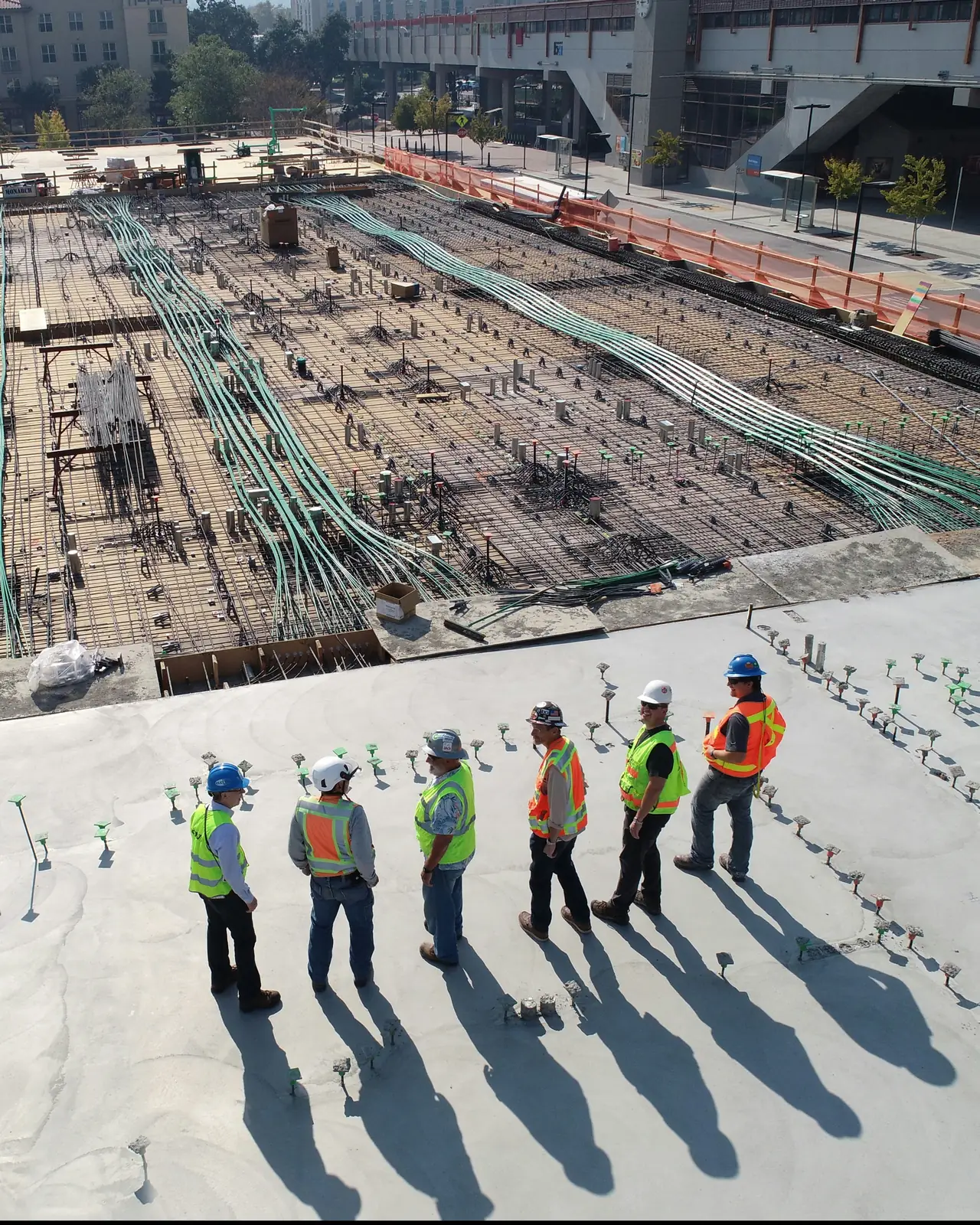 Construction project team standing together on a new concrete deck