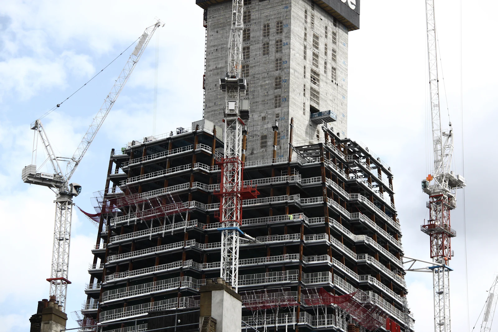 High-rise tower under construction with tower cranes